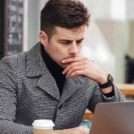 photo-businesslike-man-working-with-silver-laptop-cafe-outside-drinking-takeaway-coffee (1)